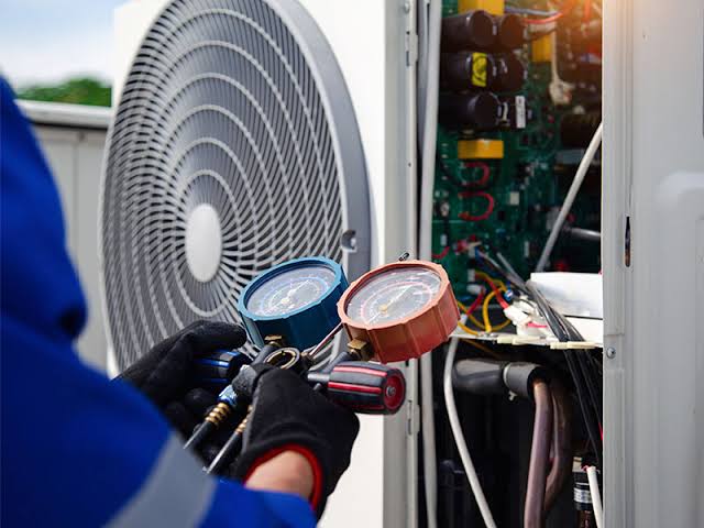 HVAC gauges connected to a residential outdoor cooling unit